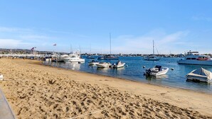 A beach with boats docked along the shore.