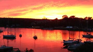 A marina with boats docked at sunset.