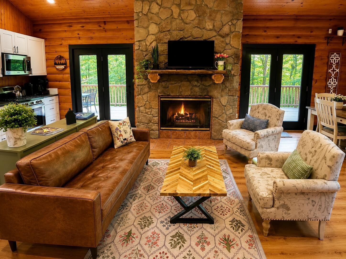 A cozy living room with a stone fireplace, leather sofa, and patterned rug.