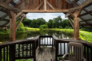 A wooden pavilion with a view of a pond and surrounding greenery. - Cozy Pondside Cabin w/ Hot Tub | Near Bloomington & Nashville (Nashville)