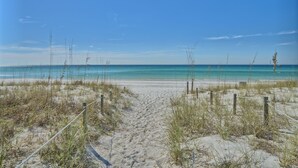 A sandy beach with a clear blue sky and ocean. - Oceanfront Dunes B406 + Free Seasonal Beach Loungers (Panama City)