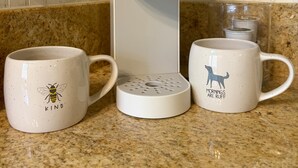 A Keurig coffee maker on a kitchen counter with two mugs, one with a bee design and the other with a dog design. - 1 King Bed Loft + Bd  , 1BA (Nashville)