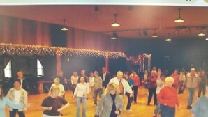 A large indoor space with a wooden floor, possibly a hall or ballroom, with a high ceiling and chandeliers. - Cowboy Guest Suite | Near Trails, Events & Music Barn 1BR, 1BA (Nashville)