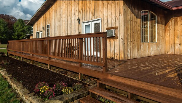 A wooden cabin with a wooden deck and a stone foundation. - Cowgirl Guest Suite | Near Trails, Events & Music Barn 1BR, 1BA (Nashville)