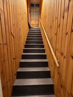 A wooden staircase with a handrail, leading to a door at the top. - Secluded Hilltop Cabin | Hot Tub, Pool Table & Near Nashville 4BR, 3BA (Nashville)