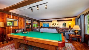 A pool table in a room with a sofa, a television, and a fireplace. - 85-Acre Family Cabin | Sleeps 12, Hot Tub & Near Nashville 4BR, 2 BA (Nashville)