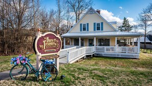 A house with a porch and a sign for "B&B Grange Vacation Home".