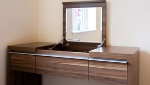 A wooden vanity with a mirror, a sink, and a cabinet. - 2-bedroom Penthouse, Clockhouse, Hoddesdon (Hoddesdon)