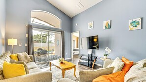 A modern living room with a sofa set, a coffee table, and a television. - 15 Mi to Disney: Home w/ Pool & Lanai in Davenport (Davenport)