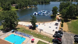 A lakeside resort with a swimming pool, beach area, and boat launch ramp. - Crown Point Resort (Horseshoe Bend)