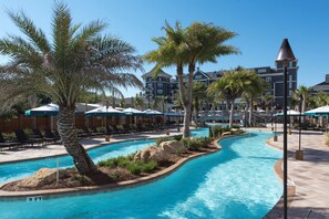 A resort pool with palm trees, lounge chairs, and umbrellas. - Spa Escape Seaside Bliss | Luxe Haven for 8 (Destin)