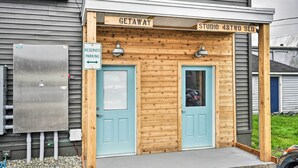 A wooden building with two doors labeled "STUDIO 4 & TWO BED" and a sign indicating "RESERVED PARKING". - Walk to Ocean! Downtown Long Beach Studio (Long Beach)