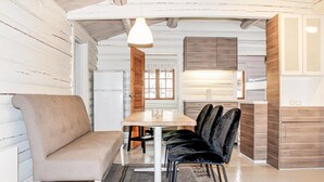 A cozy dining area with a wooden table and chairs, a bench, and a refrigerator in the background. - Awesome home in Hemsedal with WiFi (Hemsedal)