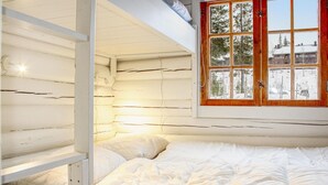 A bedroom with a bunk bed, a window with a view of trees, and a wooden wall. - Awesome home in Hemsedal with WiFi (Hemsedal)