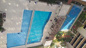 Guests can enjoy a refreshing swim in the hotel's rectangular pool surrounded by a tiled deck.