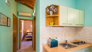 A kitchen with a toaster, sink, and cabinets. - Apartments Vodnica - One-Bedroom Apartment with Balcony and Partial Sea View (Zaton Mali)