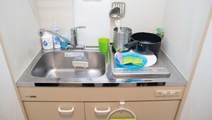 A kitchen with a sink, a dish drying rack, a green cup, and a dish soap bottle. - Viewcity Shinjukugyoen 801-2 (Tokyo)