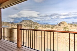 A wooden deck with a metal railing overlooking a mountainous landscape. - Rocky Mountain Hideaway | Scenic Views & Cozy Retreat (Estes Park)
