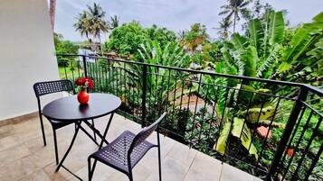 Premium Suite, Balcony, Pool View | Living area | 32-inch TV with cable channels