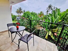 Premium Suite, Balcony, Pool View | Living area | 32-inch TV with cable channels