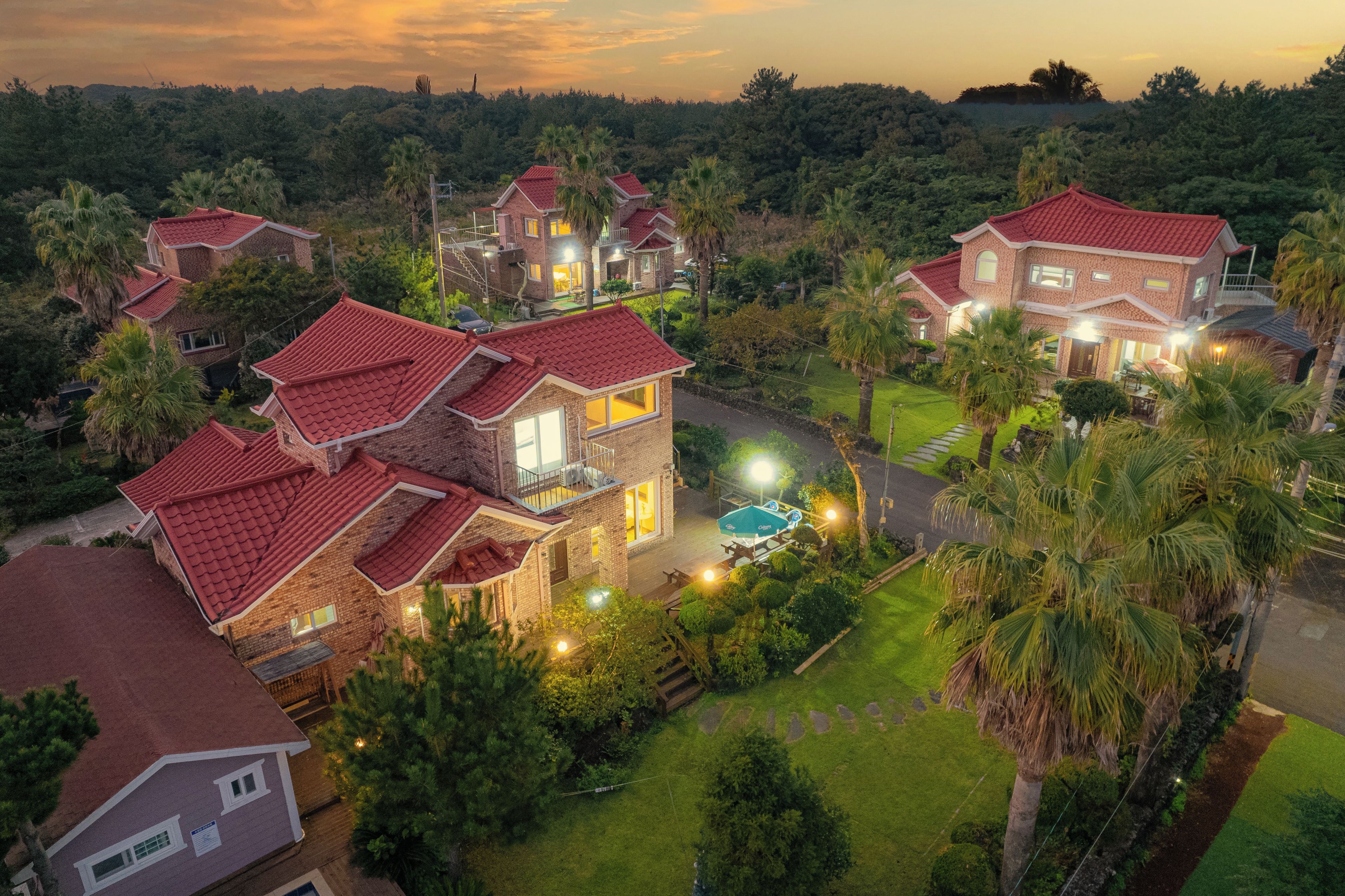 A residential area with multiple houses featuring red-tiled roofs and brick exteriors.