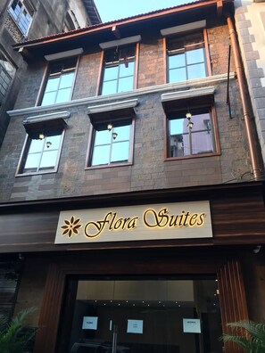 A building with a sign reading 'Flora Suites' above the entrance. - Hotel Flora Suites (Mumbai)