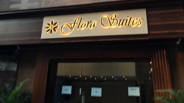 A building with a sign reading "Flora Suites" above the entrance. - Hotel Flora Suites (Mumbai)