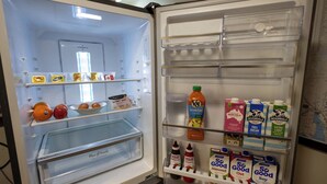 An open refrigerator with various food items and beverages. - Flinders Ranges Bed and Breakfast (HAWKER)