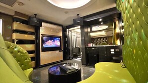 A modern hotel lobby with a television, seating area, and a reception desk. - Shining Motel (Taichung)