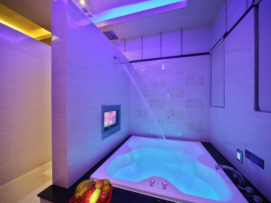 Separate tub and shower, hair dryer, slippers, towels