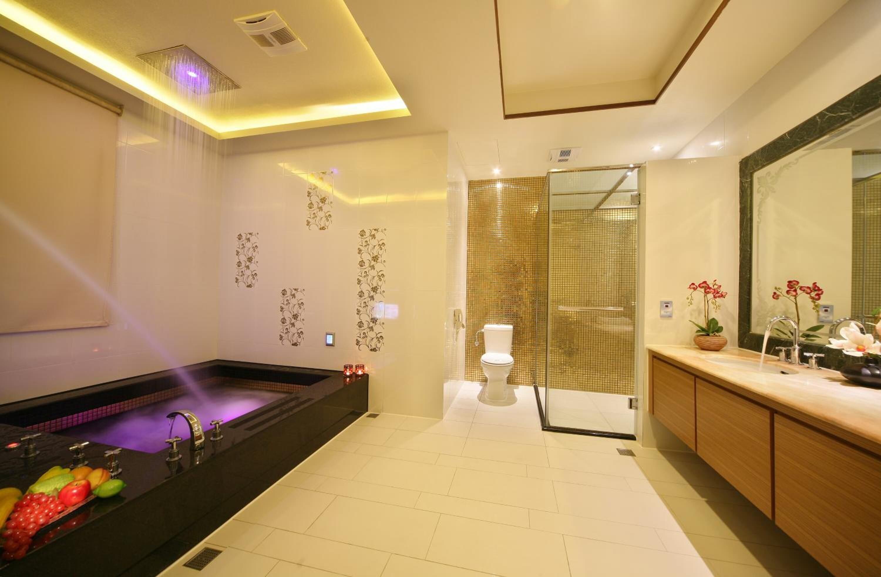 separate bathtub and shower, hair dryer, slippers, towels