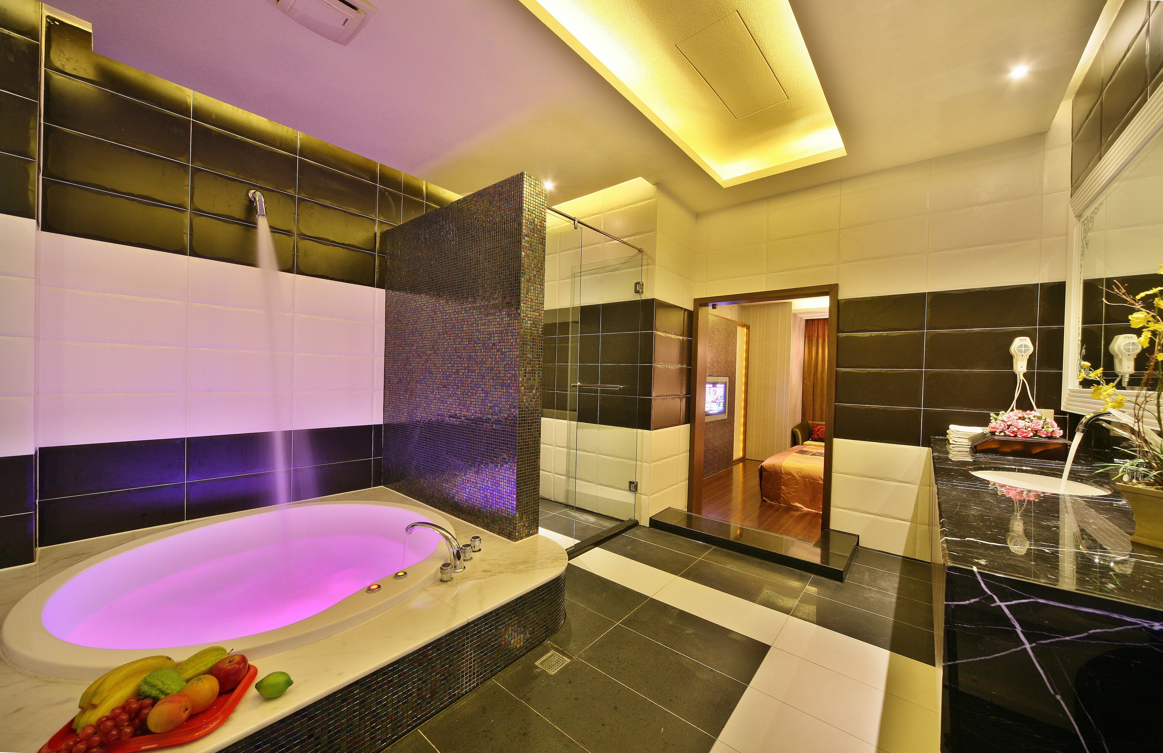 separate bathtub and shower, hair dryer, slippers, towels