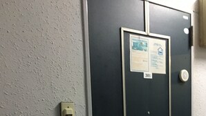 A door with a number plate, a keypad, and a card reader. - Stay inn Blue (Goto)