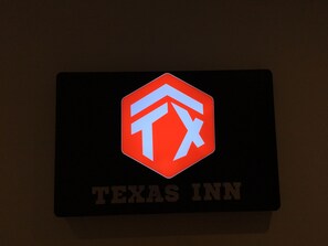 A sign with a logo and the text "TEXAS INN".