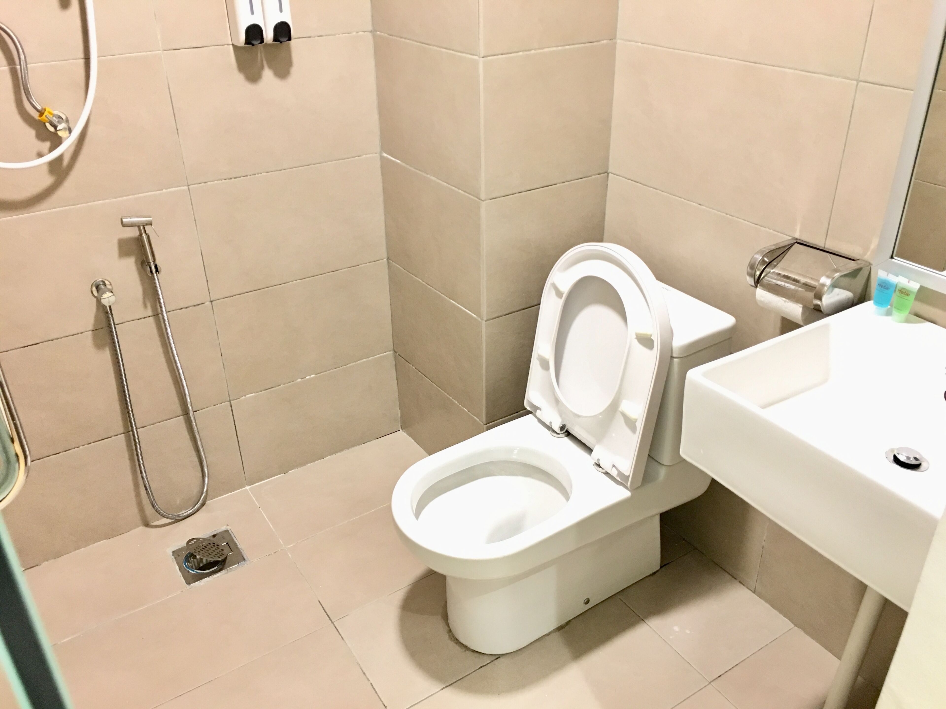 shower, hair dryer, slippers, towels