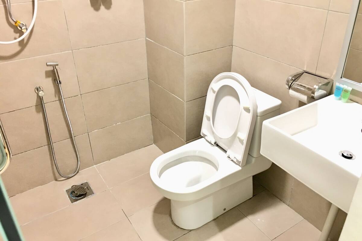 shower, hair dryer, slippers, towels