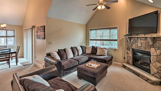 A modern living room with a sectional sofa, a fireplace, and a flat-screen TV. - 6 Mi to Skiing: Family Poconos Home w Decks! (Albrightsville)