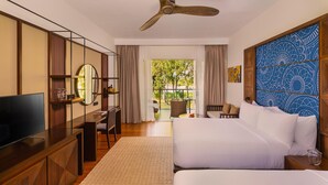 A hotel room with a large bed, a desk with a TV, a balcony with a view of greenery, and a ceiling fan. - Jetwing Kandy Gallery, A Luxury Reserve (Kandy)