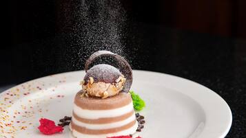 A dessert on a plate with a dark background.