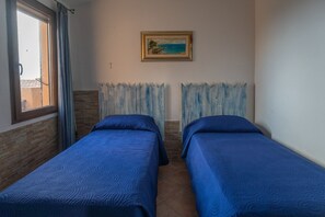 Apartment, 1 Bedroom, Patio, Sea View | 2 bedrooms, cots/infant beds, bed sheets