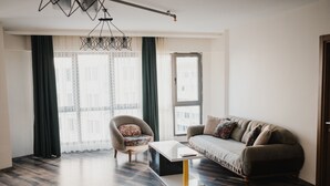 A modern living room with a sofa, armchair, and coffee table.