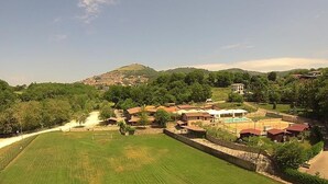 A residential area with houses, a swimming pool, and a sports field. - Bungalow with Garden View (Palestrina)