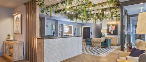 A reception area with a check-in counter, seating area, and a large window.