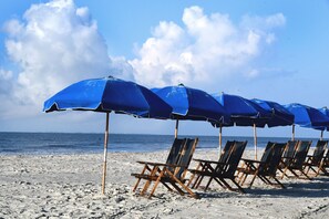 On the beach, sun-loungers