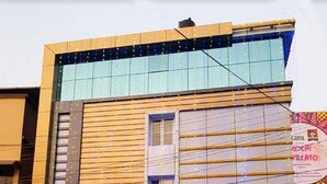 A hotel with a modern facade, a visible entrance, and a sign for 'THULASI INN'. - Thulasi Inn (Kanayannur)
