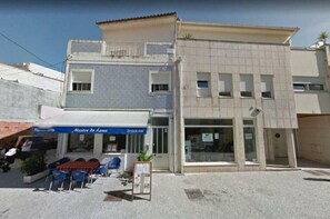 Restaurant and residential space with a balcony and garden area.