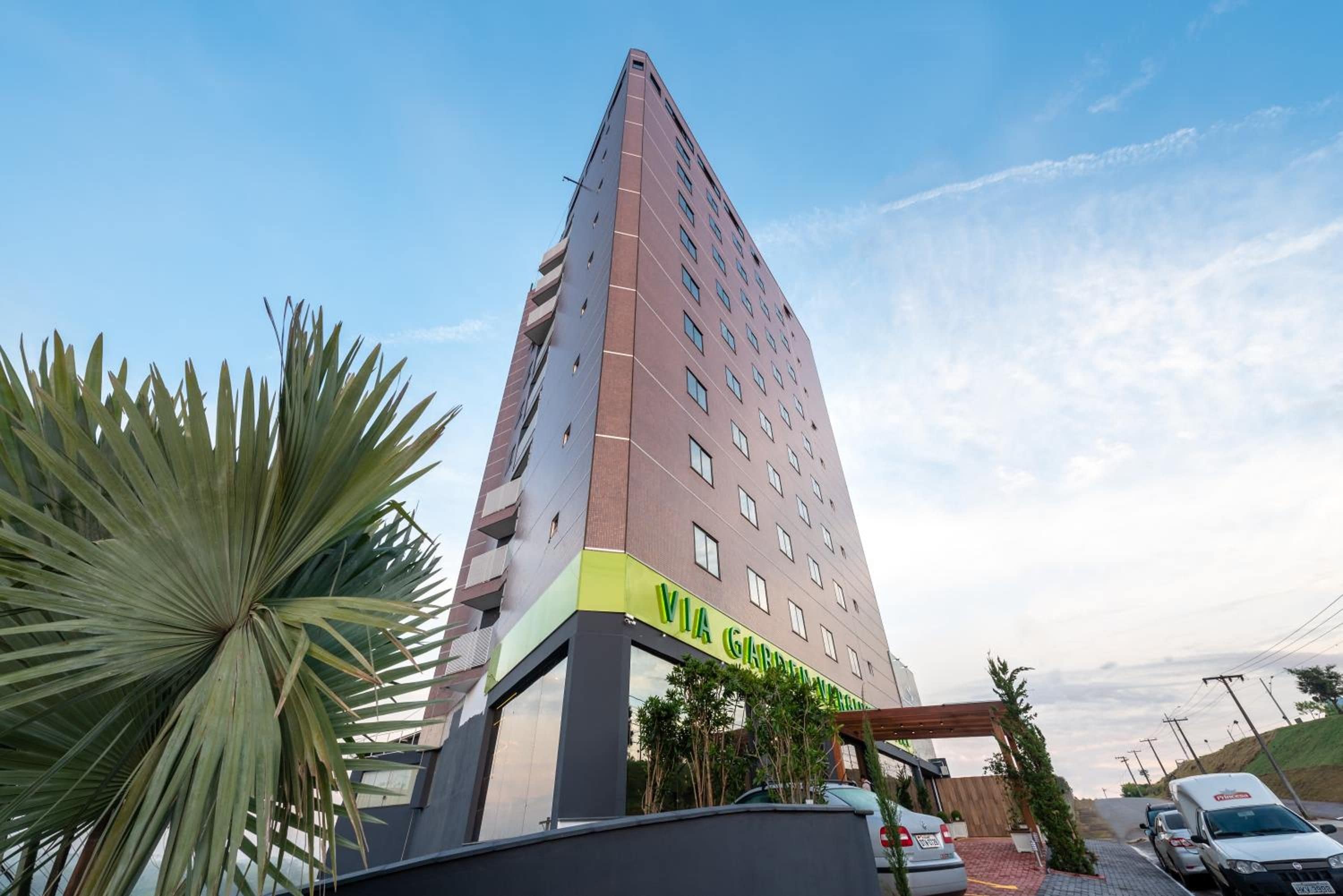 A high-rise building with a sign reading 'VIA GARANTIA' at the base.