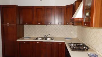 Apartment, 2 Bedrooms | Private kitchen | Full-size fridge, stovetop, cookware/dishes/utensils