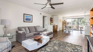A modern living room with a sofa, coffee table, and a ceiling fan.