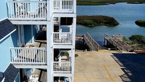 A multi-story building with balconies overlooking a body of water. - Spectacular Sunset Views  from this Top/3rd floor condo, 2 bed/2 bath (Ocean Isle Beach)